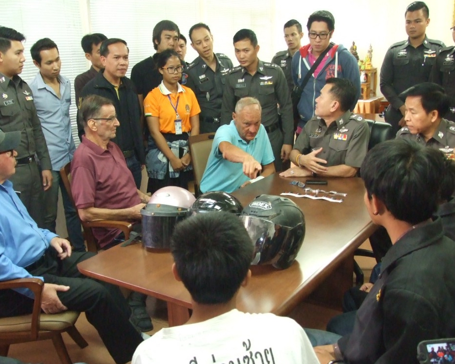 Western retirees point at their minor attackers Thursday at a police station in Udon Thani city.