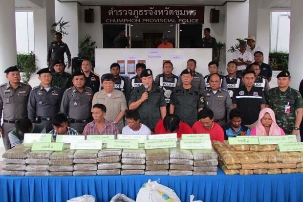 Authorities present eight suspected drug traffickers at the Chumphon provincial police headquarters on Monday. They were allegedly arrested with 400,000 speed pills and 260kg of marijuana worth over 125 million baht. (Photo by Amnart Thongdee)